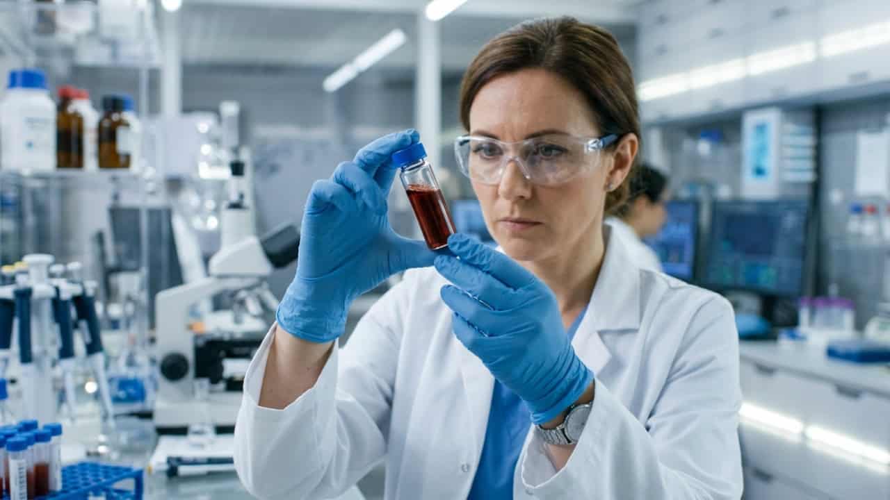 Scientist holding vial 202603251754